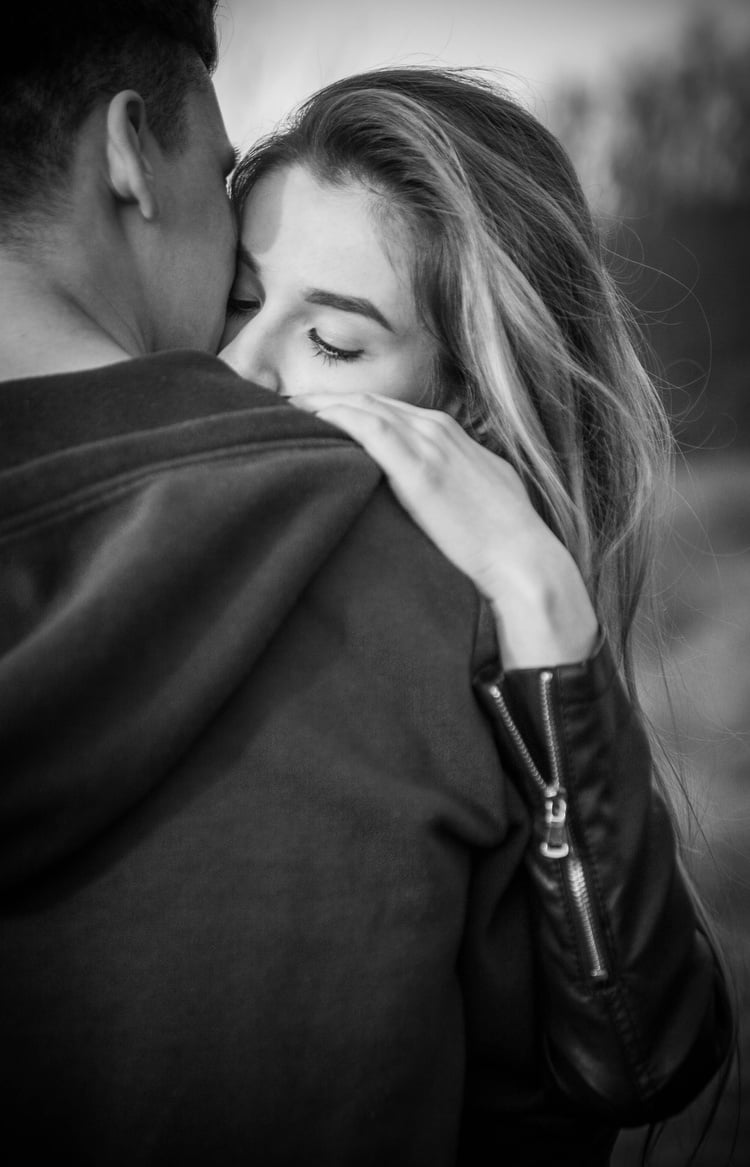 Man Hugging Woman Outdoors